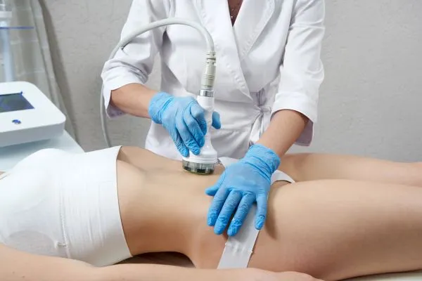 Lost the Weight but Not the Loose Skin? 2 woman having HIFU treatment on her stomach to combat loose skin Surrey following weight loss